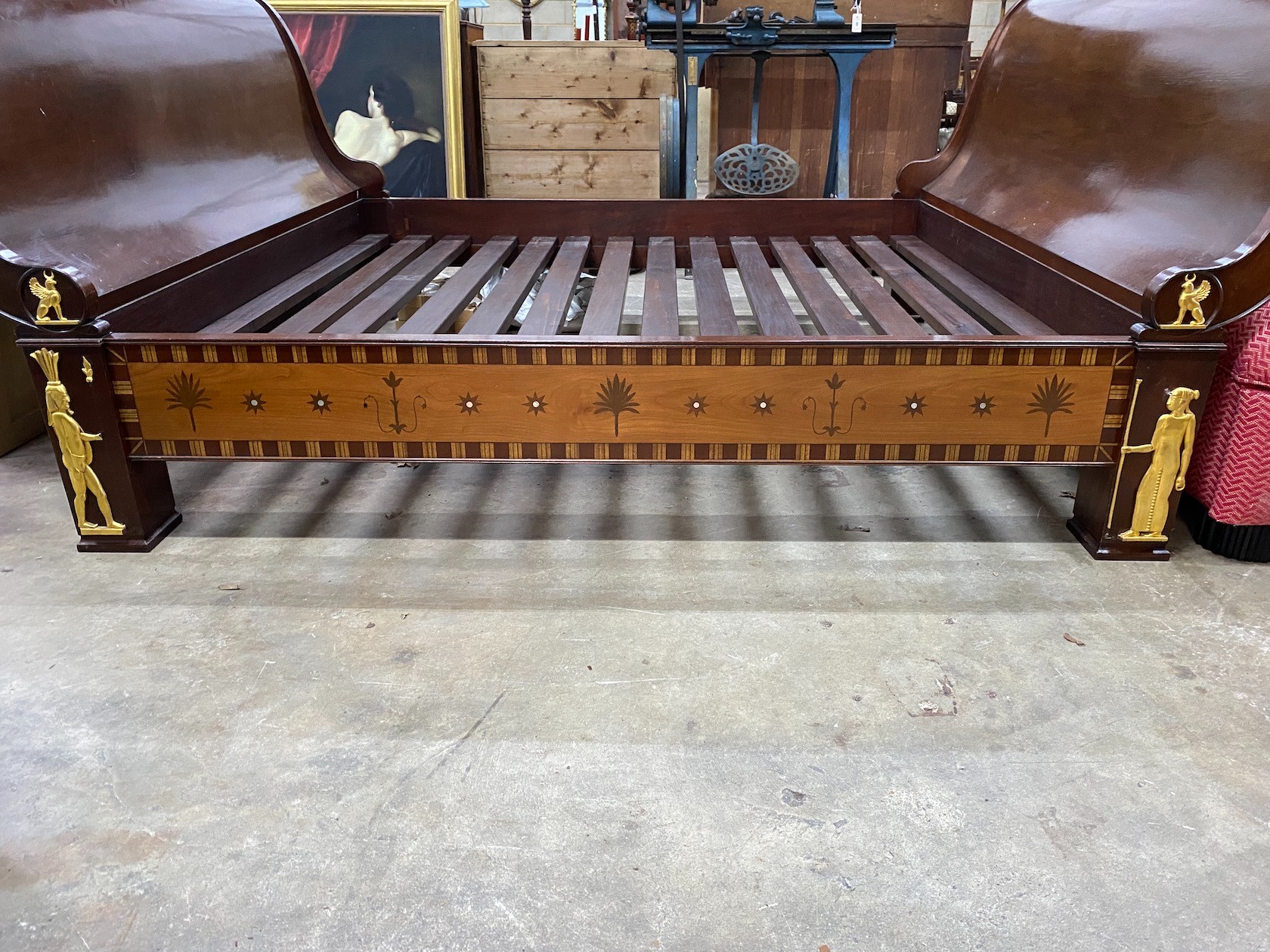 A reproduction Egyptian style inlaid gilt metal mounted mahogany sleigh bedframe, width 193cm, length 261cm, height 110cm